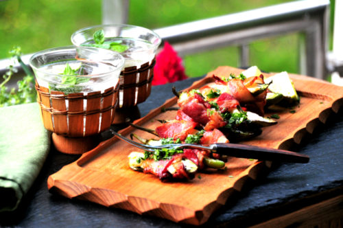 Goat Cheese and Bacon Jalapeno Poppersare on a cutting or serving board, from a keto recipe